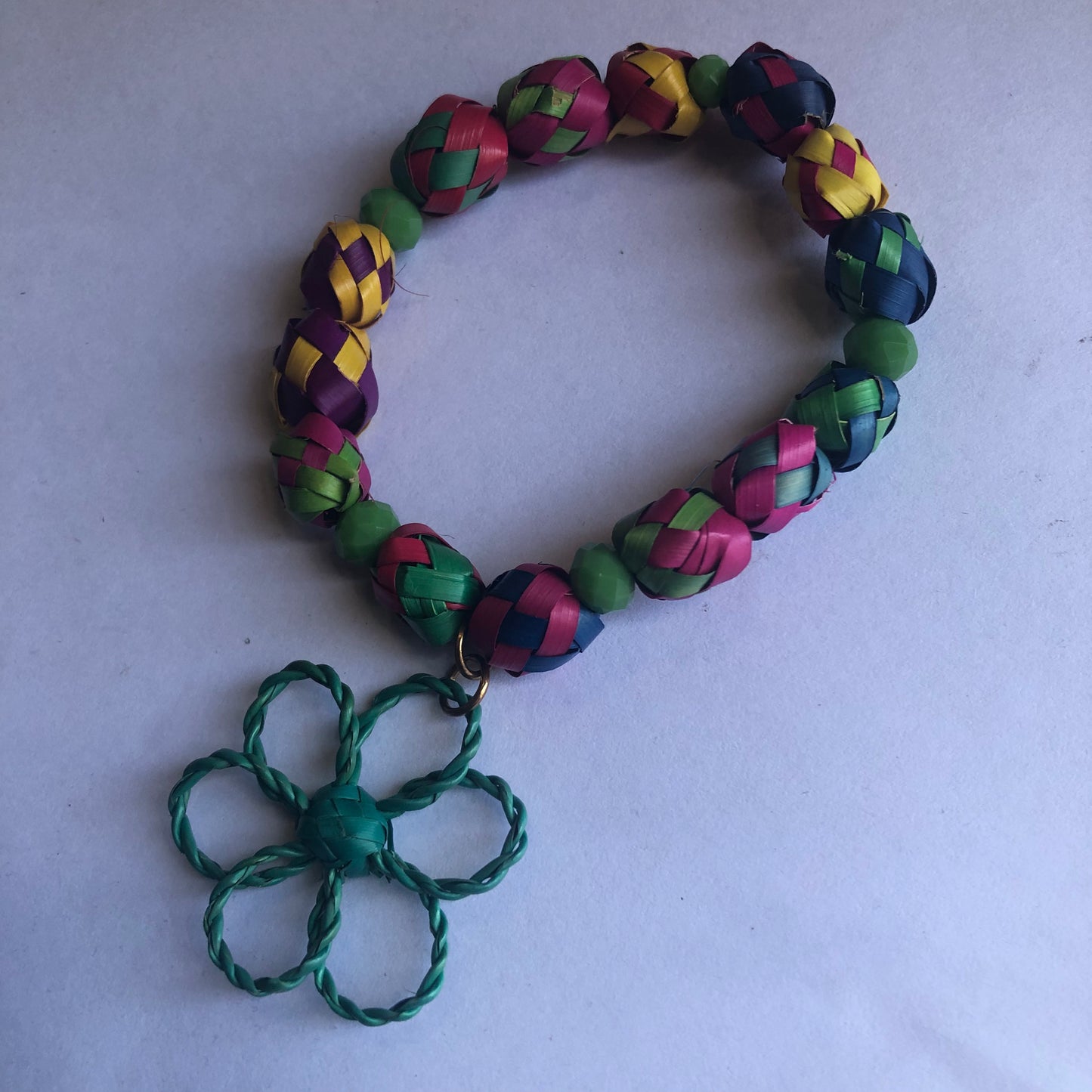 Palm leaf bracelet with flower charm
